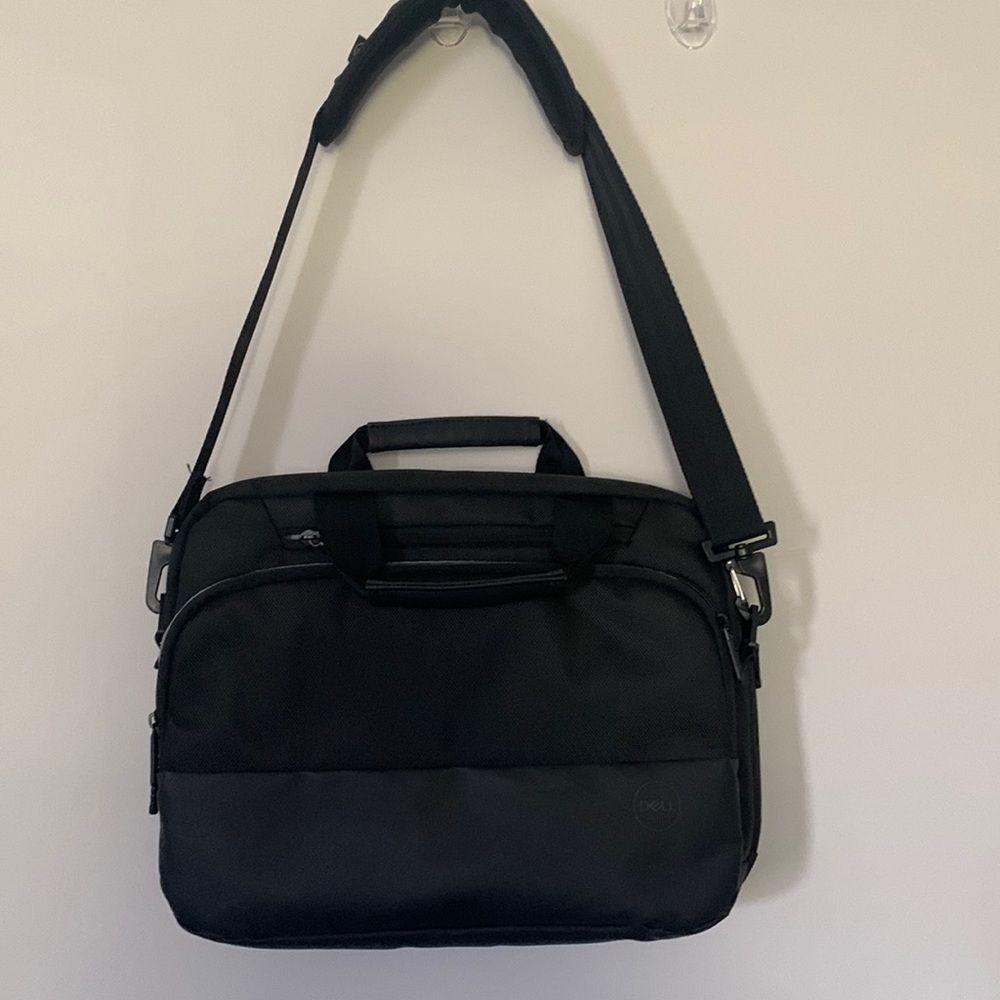 NWOT Dell laptop bag/4 zipper sleeves/Cushioned adj strap. Fits luggage handle.